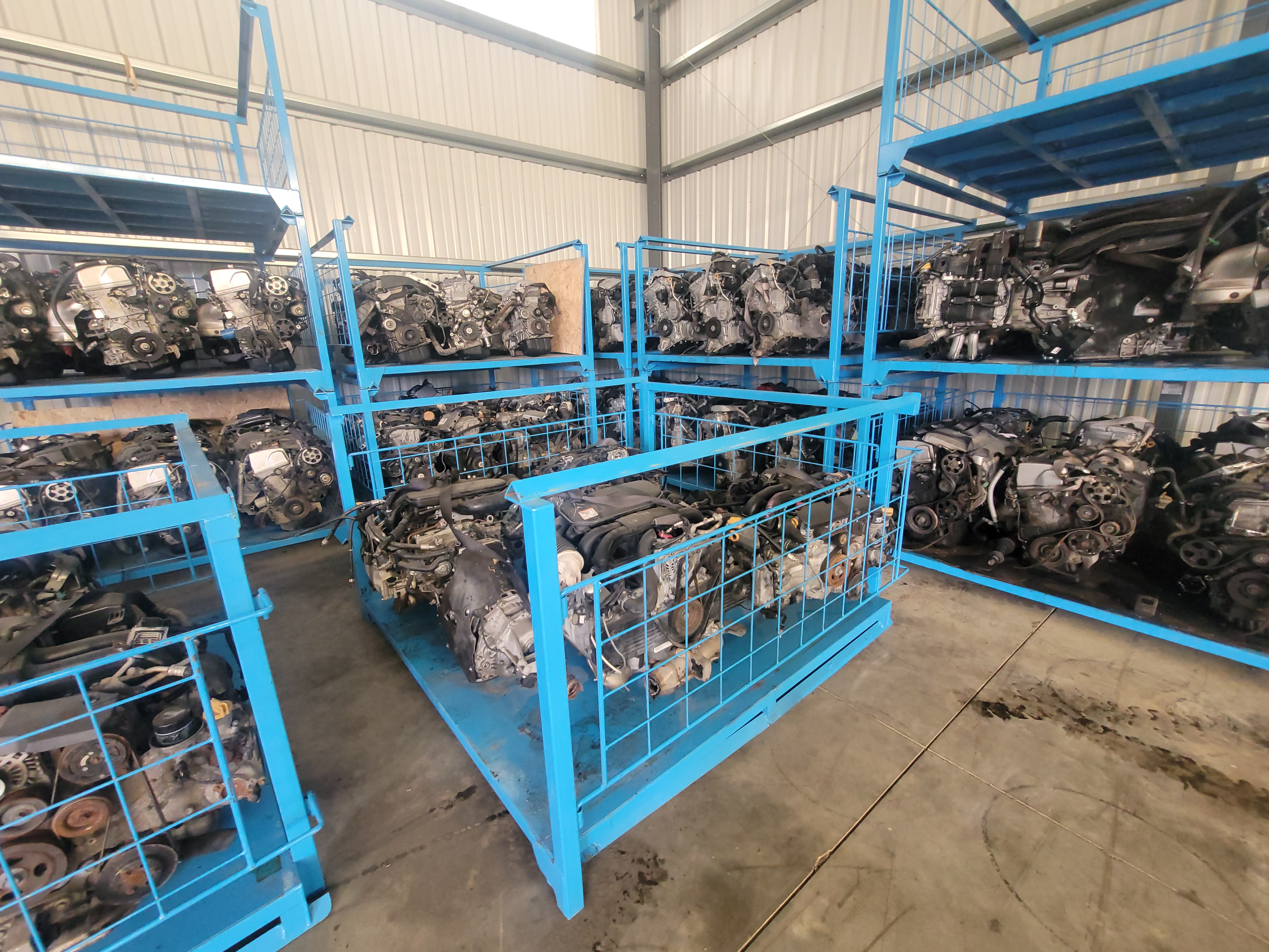 Warehouse shelf stocked with used OEM engines for European and Asian cars
